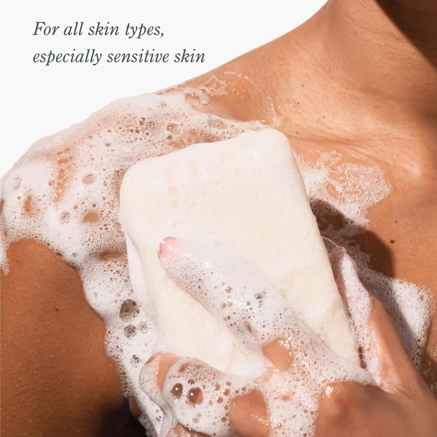 Bar of soap being rubbed onto skin with a focus on texture and care.